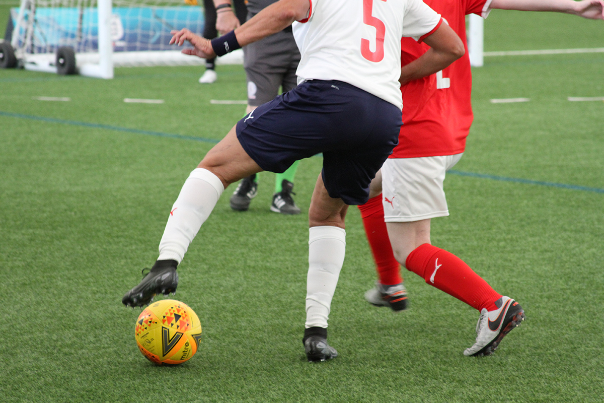 Players contesting the ball in a walking football match